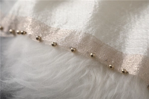 Macro detail of silk wool scarf with gold bead trim and delicate mesh fabric edge