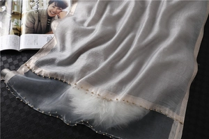 Detail of silver silk scarf featuring delicate beaded edges and champagne gold piping
