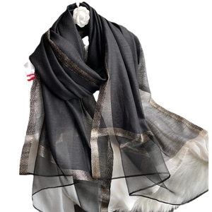 Elegant black silk wool shawl with metallic gold border and white camellia brooch