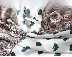 Detail of breathable houndstooth scarf with heart pattern and silky texture fabric