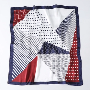 Detail of navy and red geometric scarf showing silk texture and fine stitched edges