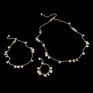 Detailed view of gold jewelry set with sparkling water drop pendants and lobster clasps