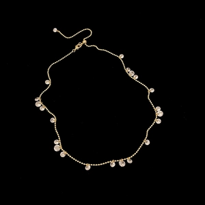 Macro view of golden bead chain necklace featuring multiple faceted crystal pendants