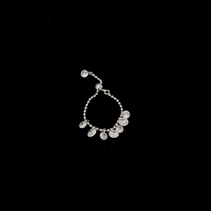 Detail of adjustable silver chain ring featuring seven sparkling teardrop zircon stones