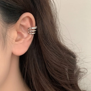 Detail of silver multi-layer ear cuff featuring sparkling cubic zirconia on the top band