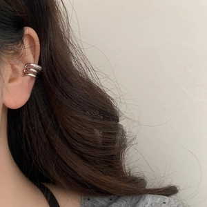 Minimalist silver triple-layered ear cuff with sparkling zircon accents on ear
