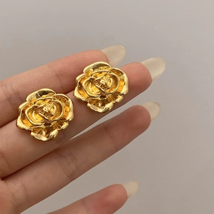 Vintage 3D gold rose stud earrings with layered metallic petals and geometric floral design