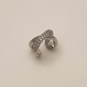 Détail d'une manchette d'oreille argentée croisée avec micro-pavage de zircone