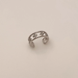 Detail view of silver ear cuff with double parallel bands and zircon-studded stars