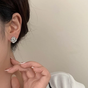 French vintage silver camellia stud earrings shown on model for an elegant floral look