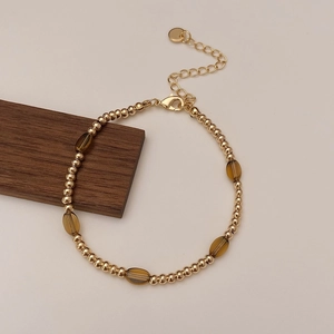 Close-up of beaded bracelet with tiger eye stones, gold beads and adjustable clasp