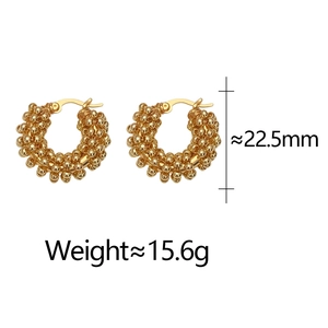 Macro detail of gold beaded hoop earrings showing 22.5mm size and textured finish