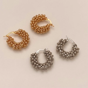Textured beaded hoop earrings in gold and silver finish with detailed woven metal design