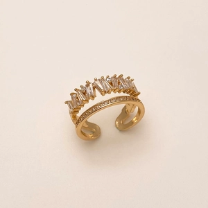 Detail of gold layered open ring featuring jagged baguette and pavé round cubic zirconia