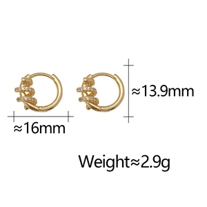 Macro view of gold hoop earrings with twisted zircon inlay and 16mm diameter size info