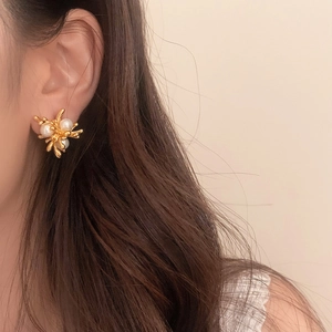 Elegant gold coral-style branch earrings with pearls worn by model for office commute