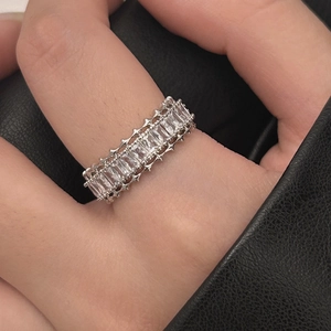 Macro view of rectangular zircons on silver ring with star-shaped edge details