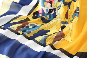 Detail shot of 70cm silk square scarf showing premium drape and striped floral pattern
