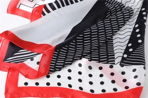 Detail of red and black geometric silk-feel scarf with polka dots and stripes