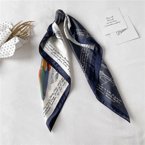 Detail of elegant navy and white silk scarf with French script print and bird motif
