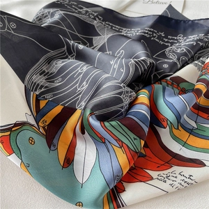Artistic detail of 70cm silk scarf with colorful feather patterns and elegant lettering