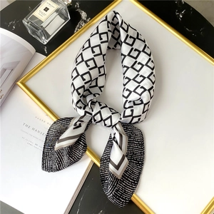 Detailed view of 70cm silk-like scarf with geometric G pattern and striped borders