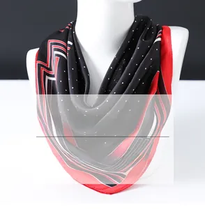 Close-up of a polka dot silk scarf in red and black tied on a mannequin neck