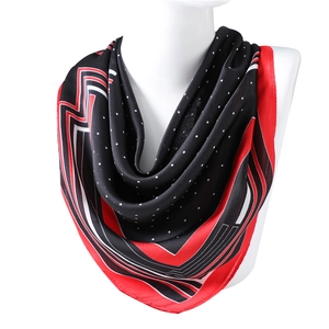 Polka dot satin silk square scarf with red stripe borders displayed on a mannequin