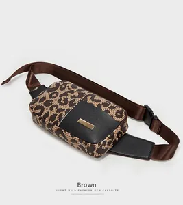 Detail of leopard print running waist bag featuring gold metal buckle and brown strap