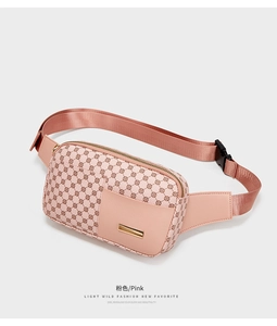 Detail of pink sports waist bag with round pattern texture and golden metal logo plate