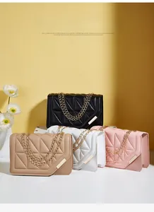 Close-up of quilted crossbody handbags with gold chain straps in four assorted colors