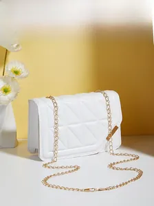Detailed view of white quilted crossbody bag with golden chain and triangular stitching