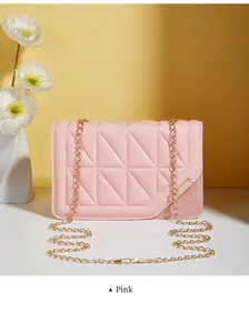 Detail of pink quilted crossbody bag with golden chain strap and magnetic lock closure