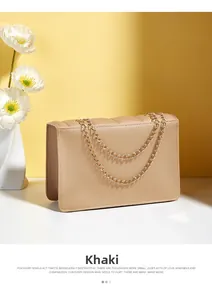 Detail of khaki quilted leather handbag with gold chain strap and magnetic lock