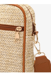 Dettaglio della trama in paglia intrecciata con finiture in pelle marrone e zip dorata