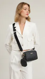 Detail of black crossbody bag with geometric print and adjustable shoulder strap