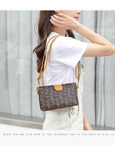 Brown leather crossbody phone bag with VIFN monogram print shown on model in outdoor setting