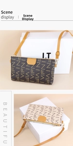 Detail of crossbody bag showing leather monogram print and silver metal hook strap