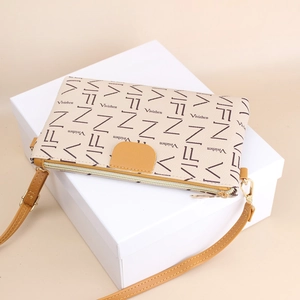 Chic cream leather crossbody phone bag with signature lettering and yellow zipper accents
