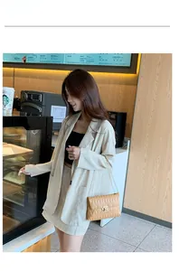 Chic mustard yellow quilted chain bag styled with a cream suit in a cafe setting