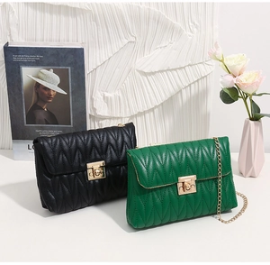 Detail of quilted PU leather flap crossbody bags with golden twist lock and chain strap
