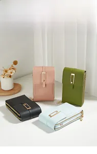 Detailed display of vertical crossbody phone bags in pink green black and blue leather