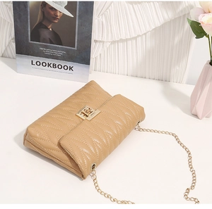 Detail of khaki quilted leather crossbody bag with golden square lock and chain strap