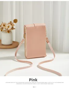 Detailed view of pink textured leather crossbody phone bag with gold zipper and strap