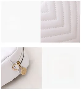 Detail of white quilted texture and golden circular metal zipper on a fashion crossbody bag