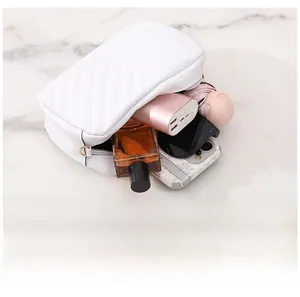 Interior view showing the large storage capacity of this white quilted crossbody bag