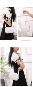 Detail of white quilted crossbody bag featuring V-shaped stitching and gold hardware