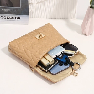 Beige quilted chain crossbody bag with gold lock and interior capacity display
