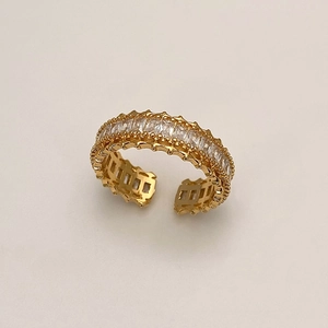 Macro view of gold adjustable ring featuring pavé rectangle zircons and beaded edge details