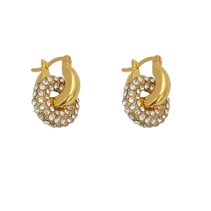 Detailed close-up of intertwined gold hoop earrings with zircon pavé setting design
